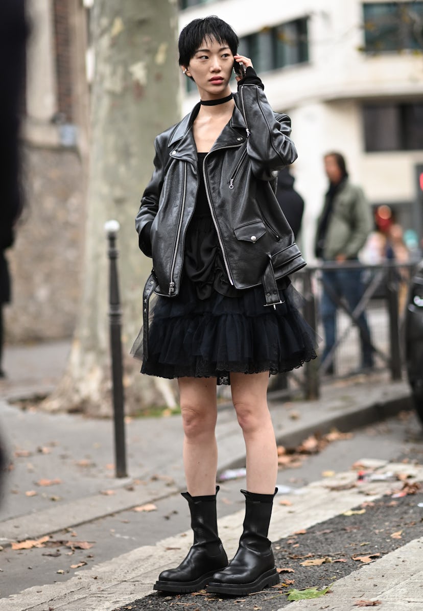 PARIS, FRANCE - OCTOBER 03: Model Sora Choi is seen wearing a black leather jacket and black dress o...