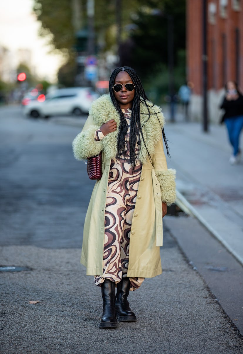 PARIS, FRANCE - SEPTEMBER 29: Lois Opoku seen wearing dress with print, shearling coat outside Acne ...