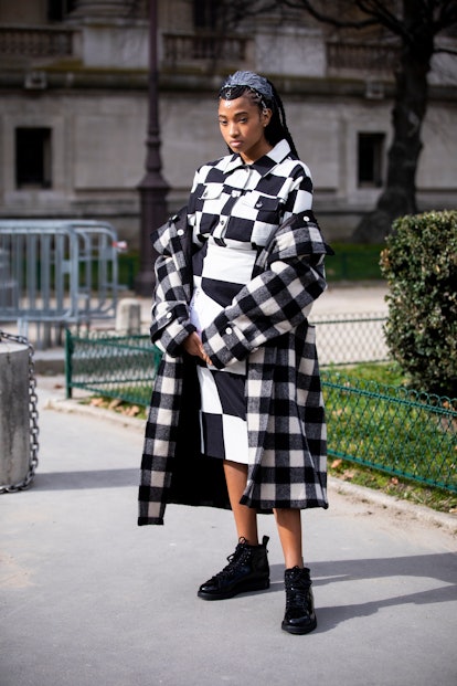 A high-top sneaker outfit with a knit top, skirt, and coat.