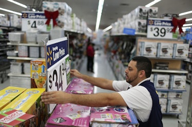 A worker fixes a display in the aisle at a Walmart store as they prepare for Black Friday shoppers o...