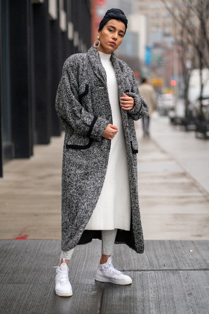 A high-top sneaker outfit featuring a dress, leggings, coat, and sneakers. 