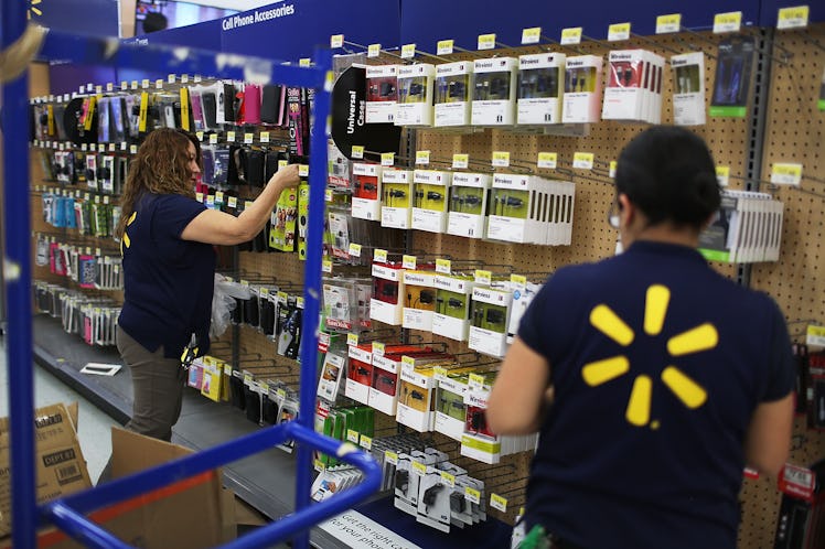 Workers restock a display at a Walmart store as they prepare for Black Friday shoppers.
