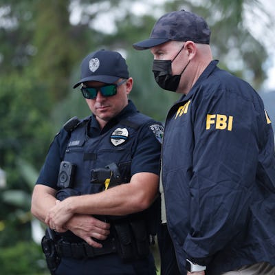 NORTH PORT, FL - SEPTEMBER 20: An FBI agent talks with a North Port officer while they collect evide...