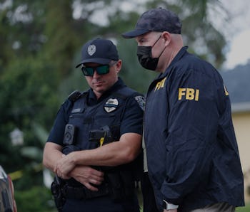 NORTH PORT, FL - SEPTEMBER 20: An FBI agent talks with a North Port officer while they collect evide...