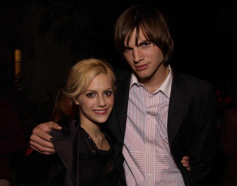 Brittany Murphy & Ashton Kutcher take a photo together at a public event. 