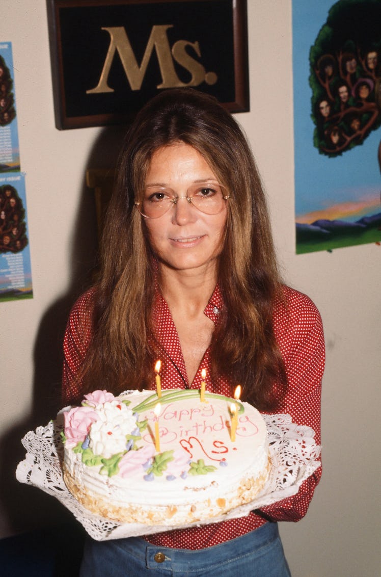 Portrait of American women's rights activist and author Gloria Steinem as she poses with a birthday ...