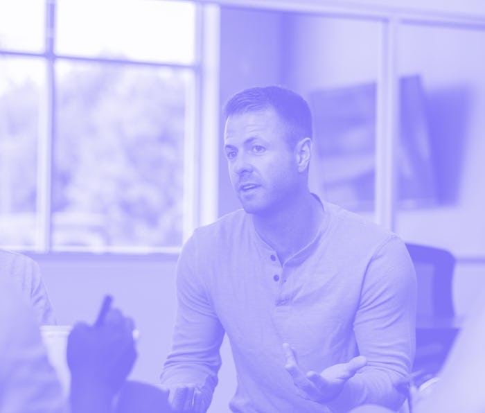 Man gesturing with hand in therapy meeting