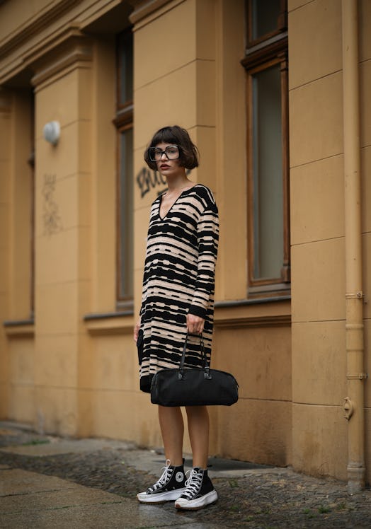 A high-top sneaker outfit with a sweater dress and bag.