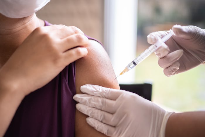Doctor injecting vaccine on patient's arm