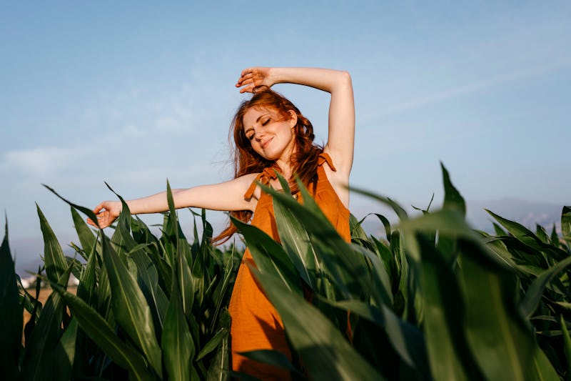 A woman dances in a corn field during the November 2021 Full Moon.