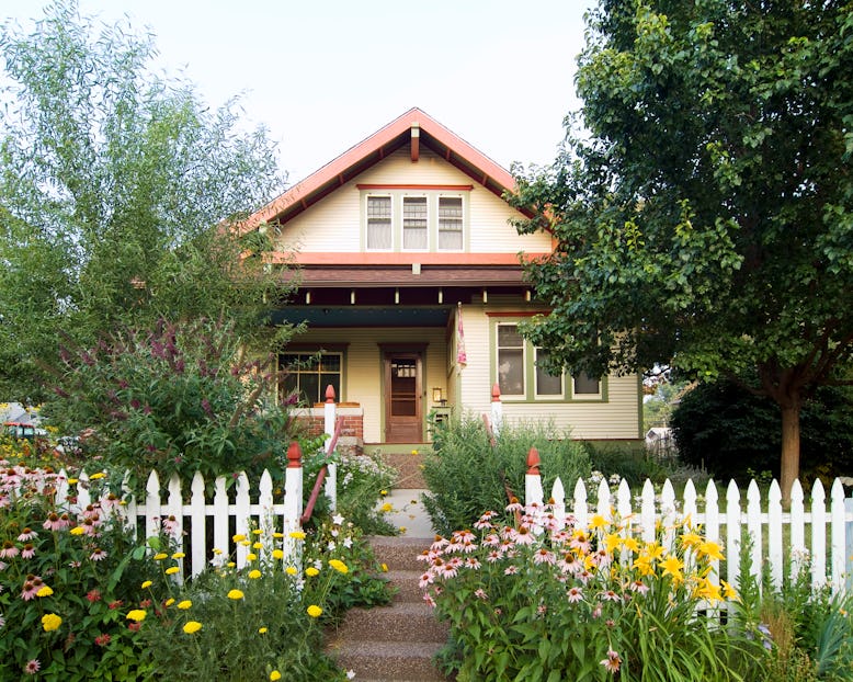 A typical suburban house with a white picket fence. One writer redefines home as a second-generation...