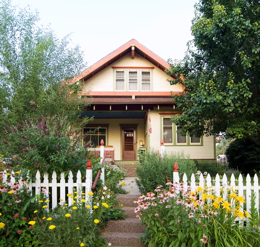A typical suburban house with a white picket fence. One writer redefines home as a second-generation...