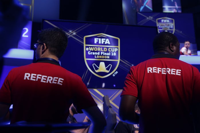 Referees monitor the play as players compete on Microsoft Xbox and Sony Playstation games consoles i...