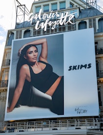 A SKIMS poster of Kim Kardashian West. The brand is having a Black Friday 2021 sale.