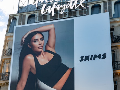 A SKIMS poster of Kim Kardashian West. The brand is having a Black Friday 2021 sale.
