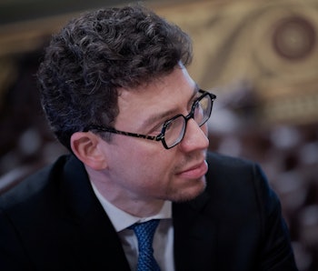 Duolingo CEO Luis von Ahn listens as US Vice President Kamala Harris (off frame) makes a statement f...