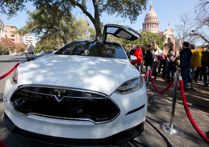 Small group of people gather to participate in Tesla Motors test drives outside the Texas Capitol bu...