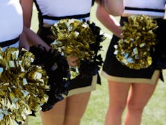 Three cheerleaders in their outfits.