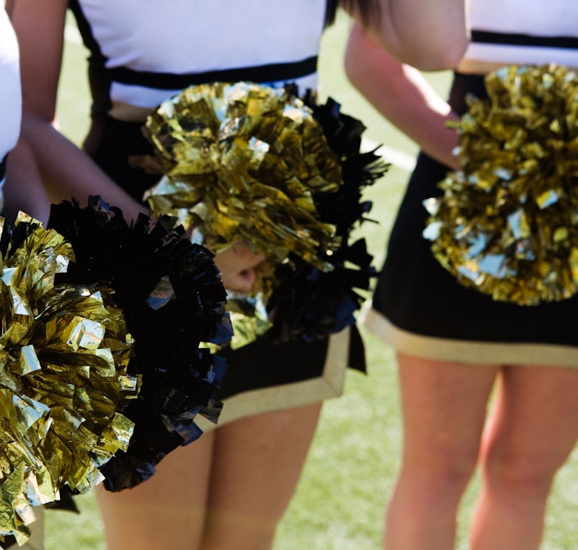 Three cheerleaders in their outfits.