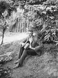 (Original Caption) American author and journalist Ambrose Bierce. Photograph, sitting under tree. Un...