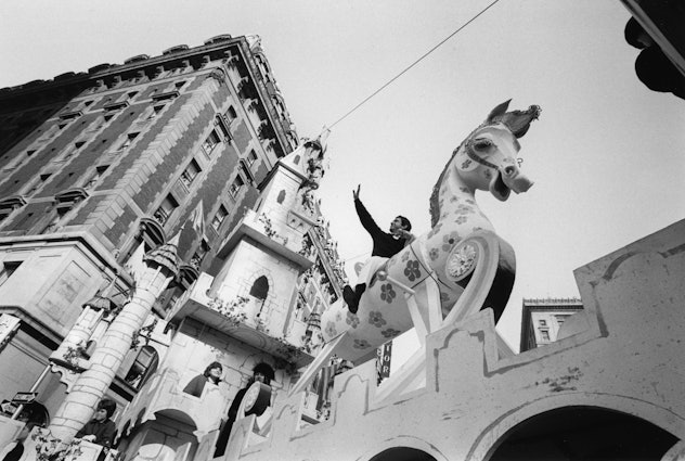 TV comic Soupy Sales waves to the crowd from atop his huge rocking horse float as Macy's annual Than...