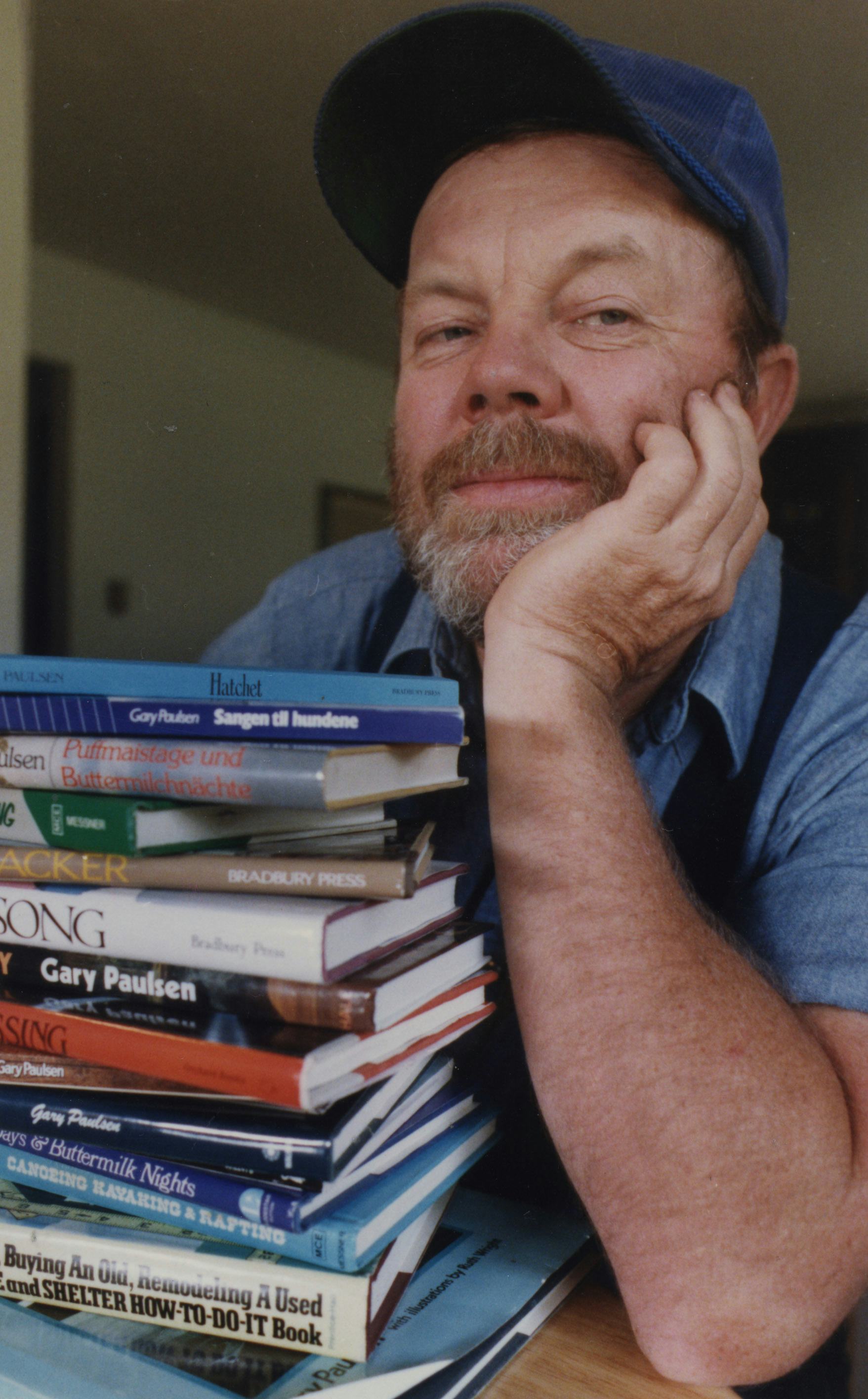 Gary Paulsen, author, is shown with some of his books. Photo is one of several for a feature on Paul...