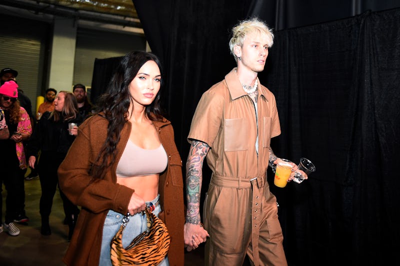 Megan Fox and Machine Gun Kelly arrive backstage at a UFC fight. Megan Fox and Machine Gun Kelly's a...