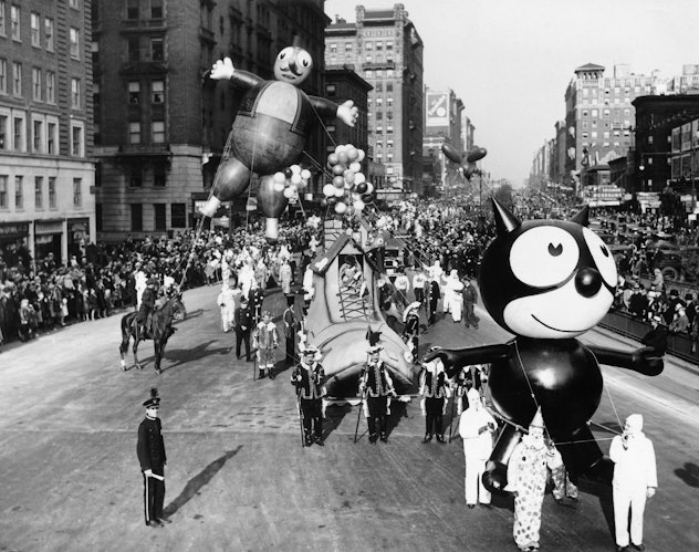 A Felix the Cat balloon and other parade floats and balloons are led down Broadway during the annual...