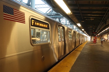 NEW YORK, NY - AUGUST 2: An F train waits to pull out of the Smith - 9th Street station in Brooklyn ...