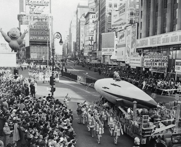 (Original Caption) Macy's 1955 Thanksgiving Day Parade passes Times Square in New York City.