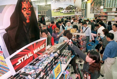 Japanese Star Wars fans rush to the Star Wards section of a Tokyo toy shop as Star Wars toys go on s...