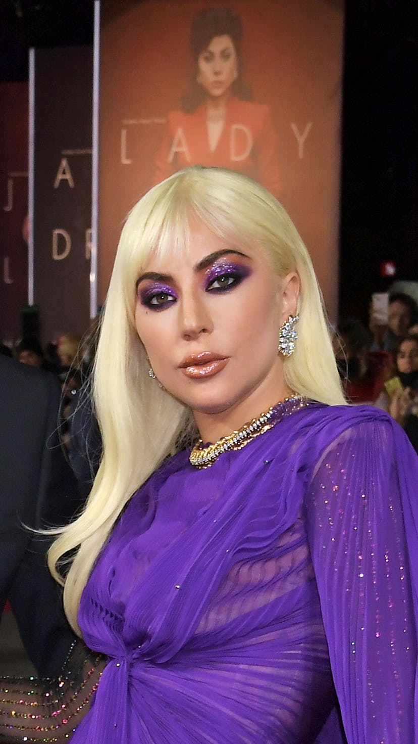 Lady Gaga at the House Of Gucci UK premiere wearing new bangs and metallic purple makeup, all by her...