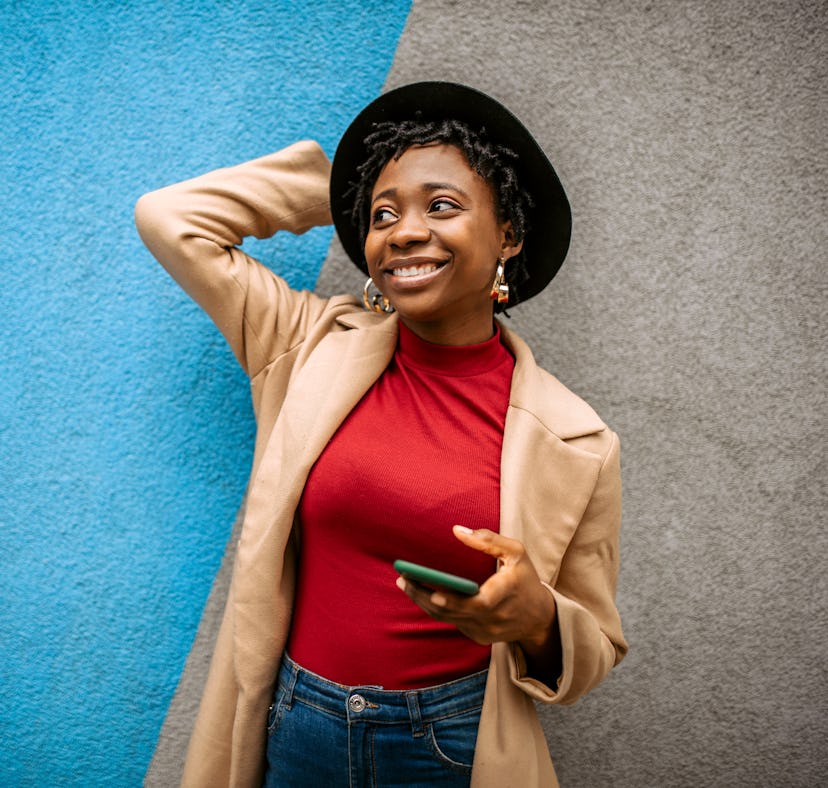Young woman with a fun hat, having the best week of December 6, 2021, per her lucky zodiac sign's we...