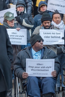 Wheelchair advocates joined by taxi and livery drivers rally on the steps of New York City Hall on T...
