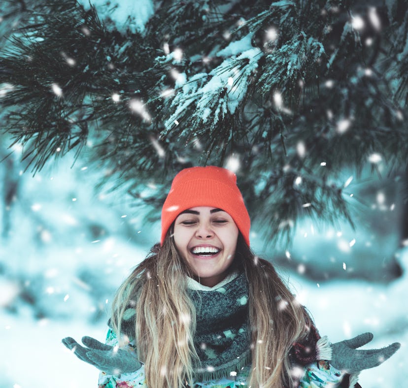 Woman playing in snow, thinking about how December 13, 2021 will be the best week for her zodiac si...
