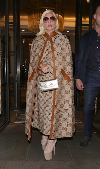 Lady Gaga wears cape and dress from Gucci Fall 2021.
