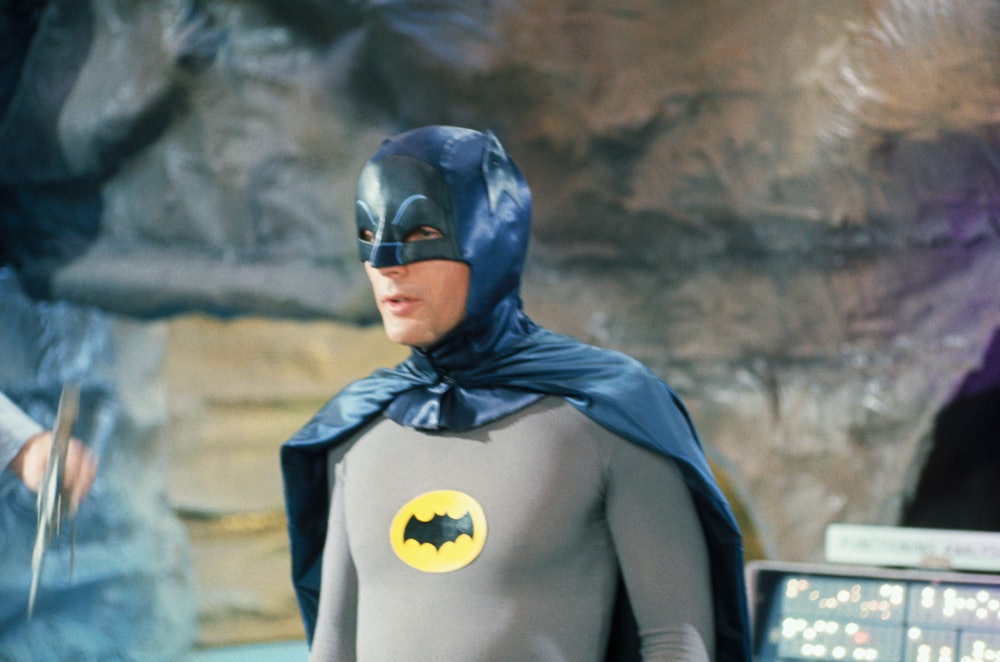(Original Caption) Adam West at Batman in costume during filming of one of the shows.