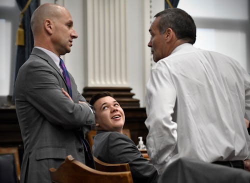 KENOSHA, WISCONSIN - NOVEMBER 09: Kyle Rittenhouse, center, looks up at his attorneys Corey Chirafis...