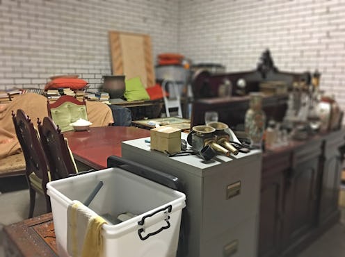 Messy storage room with many old home stuff and boxes.