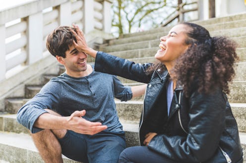 A woman playfully pushes away a friend of hers. Here’s your daily horoscope for November 16, 2021.