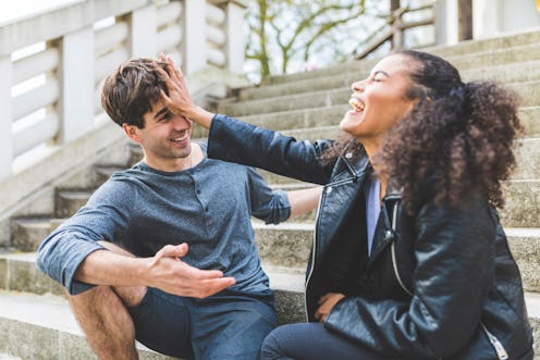 A woman playfully pushes away a friend of hers. Here's your daily horoscope for November 16, 2021.