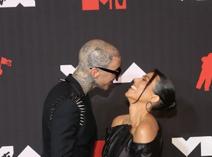 Kourtney Kardashian and Travis Barker at the 2021 MTV VMAs. In November, Kardashian straddled Barker...