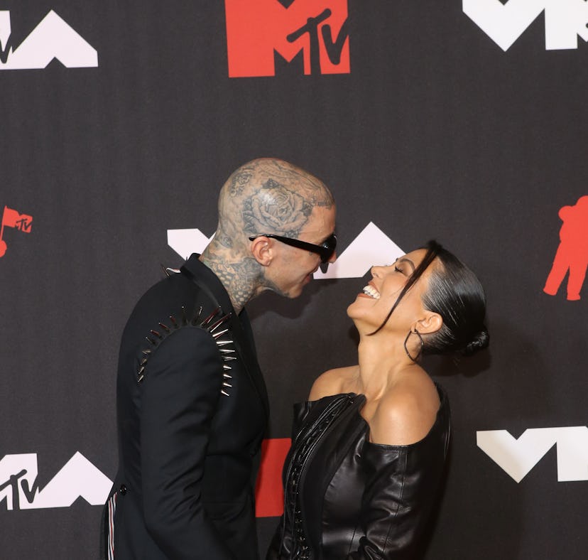 Kourtney Kardashian and Travis Barker at the 2021 MTV VMAs. In November, Kardashian straddled Barker...
