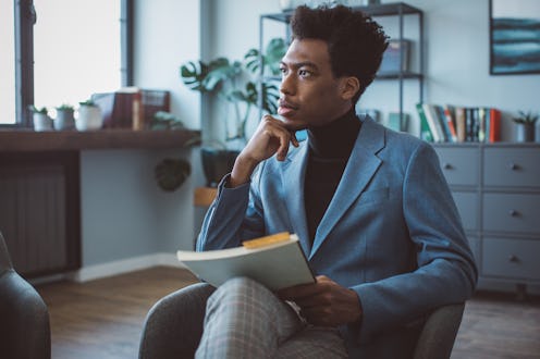 Young man at office on meeting. He is book author and talking with publisher.