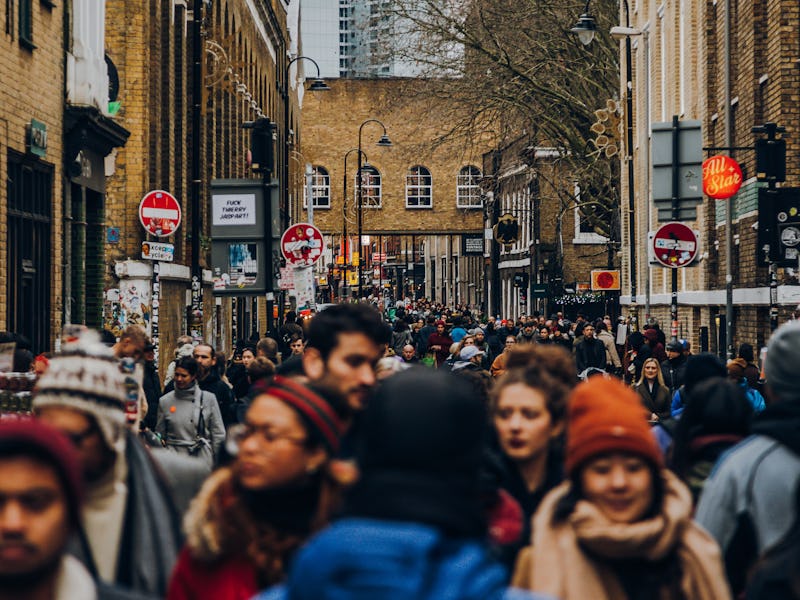 Tourists browsing shops and market stalls on Brick Lane District in London, United Kingdom