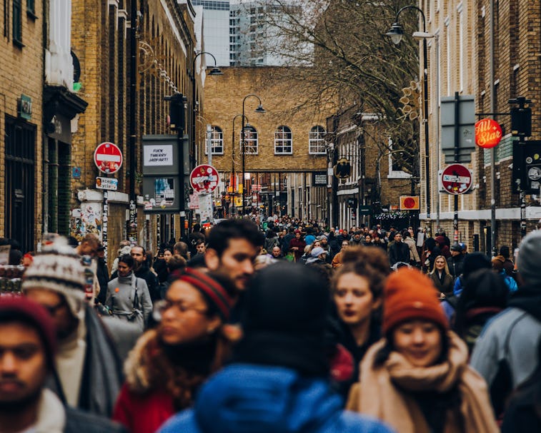 Tourists browsing shops and market stalls on Brick Lane District in London, United Kingdom