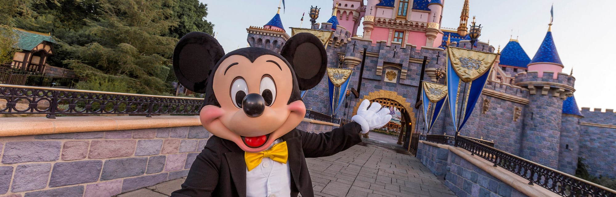 ANAHEIM, CA - AUGUST 27: Mickey Mouse poses in front of Sleeping Beauty Castle at Disneyland Park on...