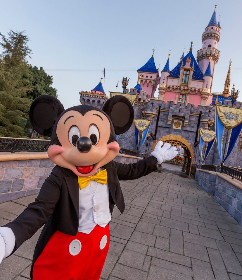 ANAHEIM, CA - AUGUST 27: Mickey Mouse poses in front of Sleeping Beauty Castle at Disneyland Park on...