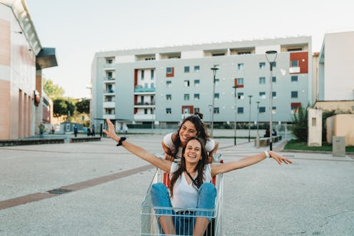 A woman pushes a friend around in a shopping cart. An astrologer explains Scorpio zodiac sign's hidd...