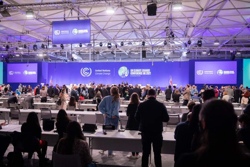 13 November 2021, United Kingdom, Glasgow: Delegates stand together at the UN Climate Change Confere...